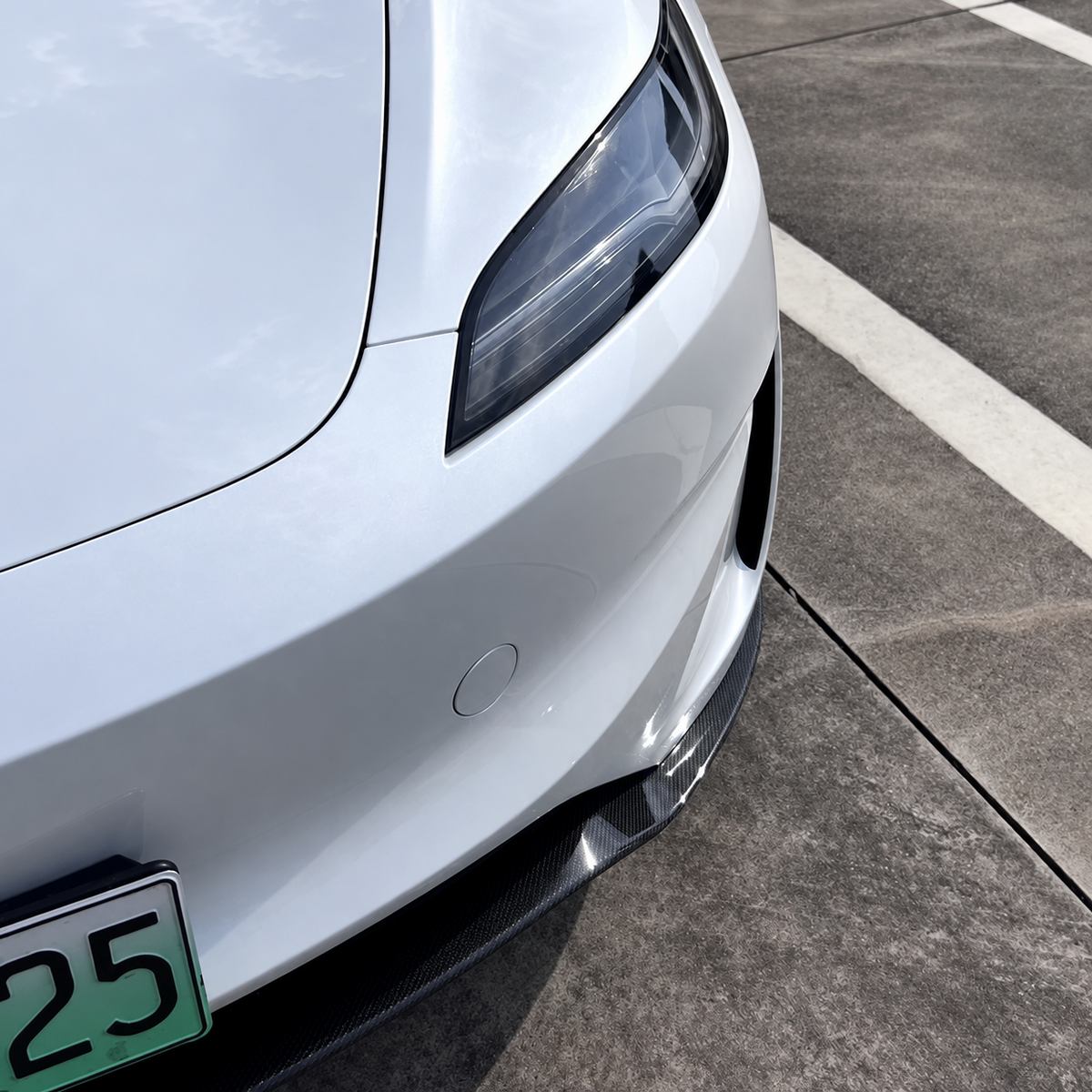 Gloss carbon fiber front lip installed on Tesla Model 3 Highland Performance - view 2